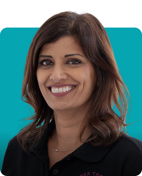 Smiling woman with shoulder-length brown hair and teal backdrop.